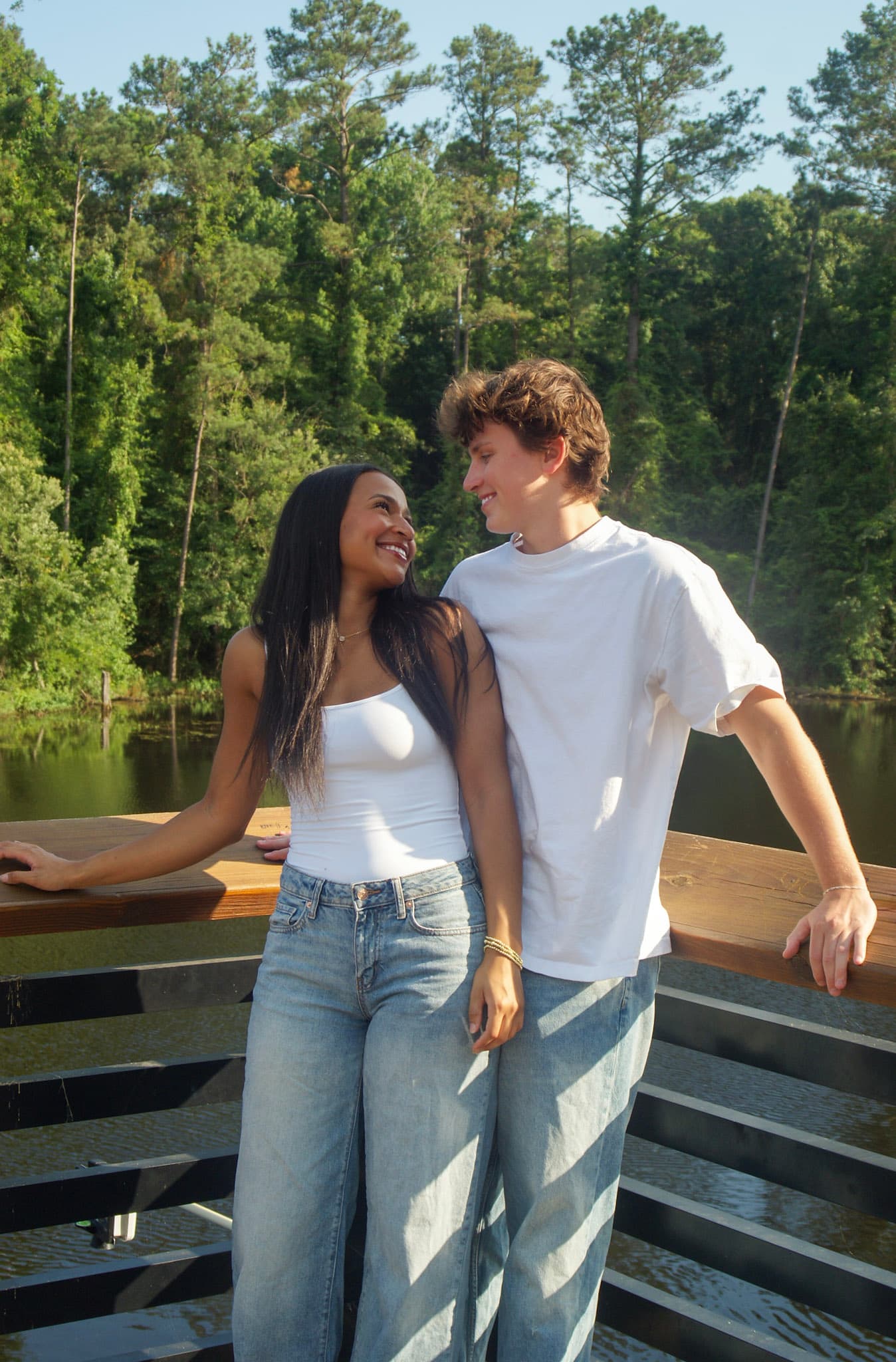 Couple portrait on a lakeside deck in warm outdoor light
