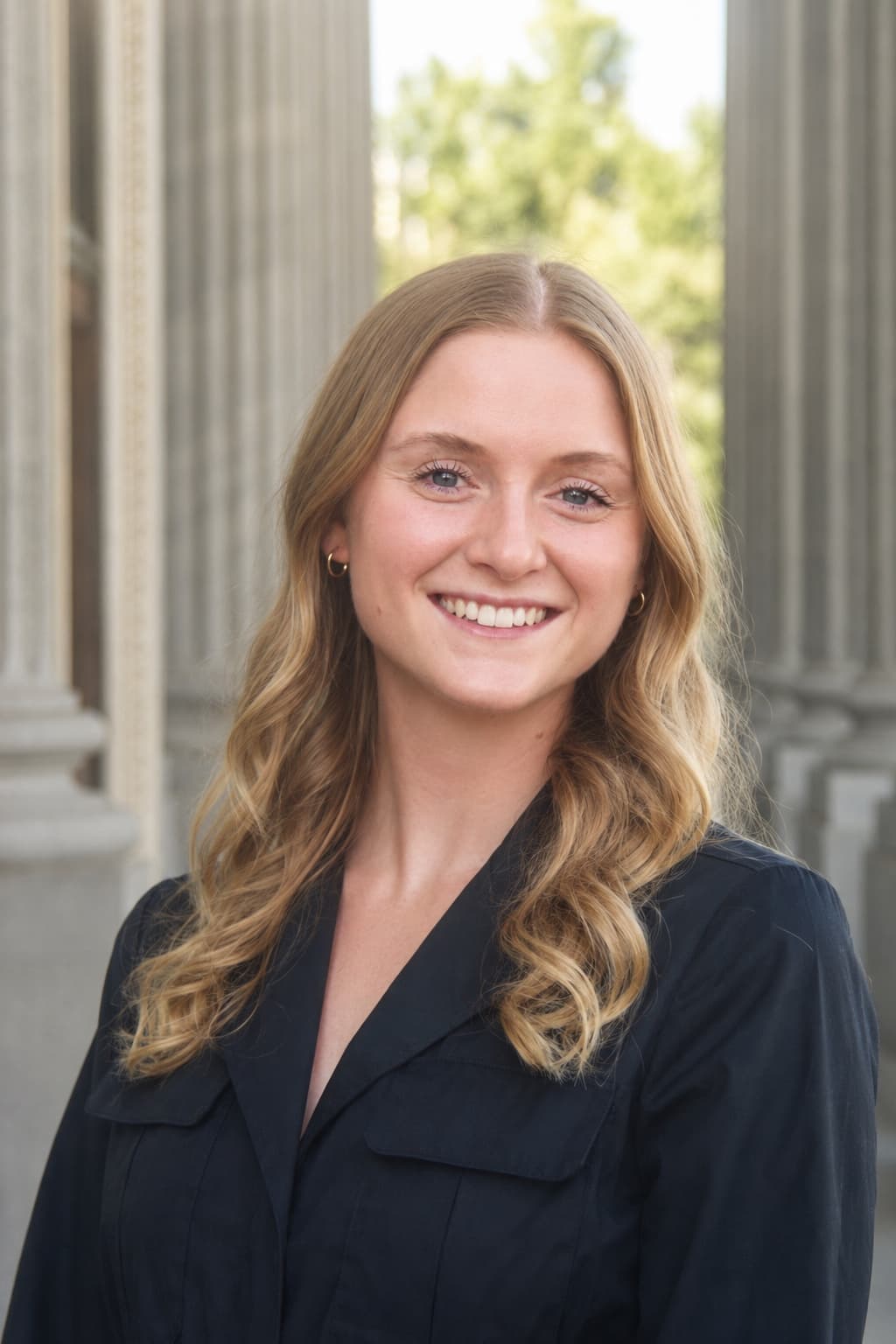 Professional headshot of a woman near architectural columns